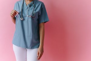 Photo by Thirdman : https://www.pexels.com/photo/a-medical-professional-holding-a-pink-ribbon-7659778/